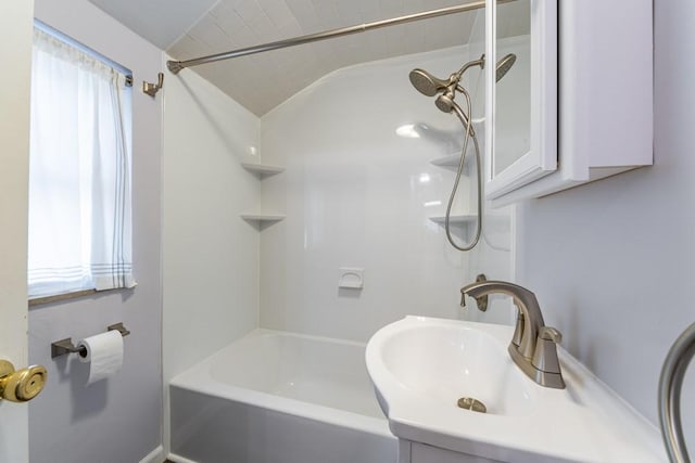 bathroom featuring a sink and vaulted ceiling