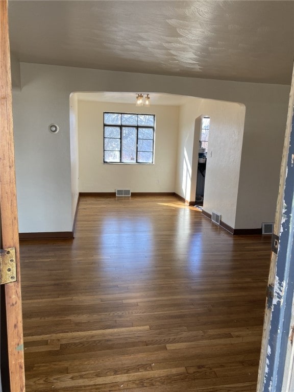 empty room with dark wood-type flooring