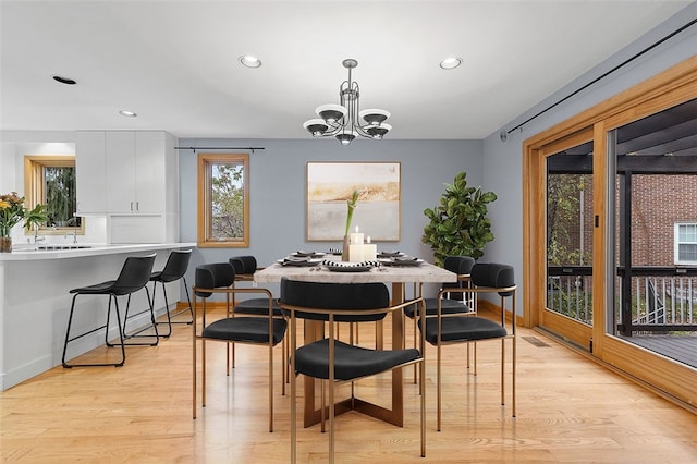 dining room featuring light hardwood / wood-style flooring and an inviting chandelier