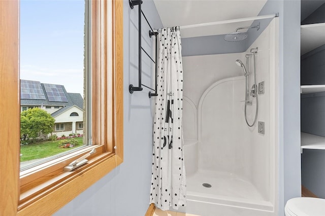 bathroom featuring toilet and a shower with curtain