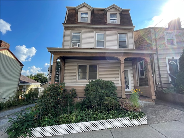 view of front of home with cooling unit and covered porch