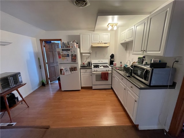 kitchen with white cabinets, light hardwood / wood-style flooring, sink, and white appliances