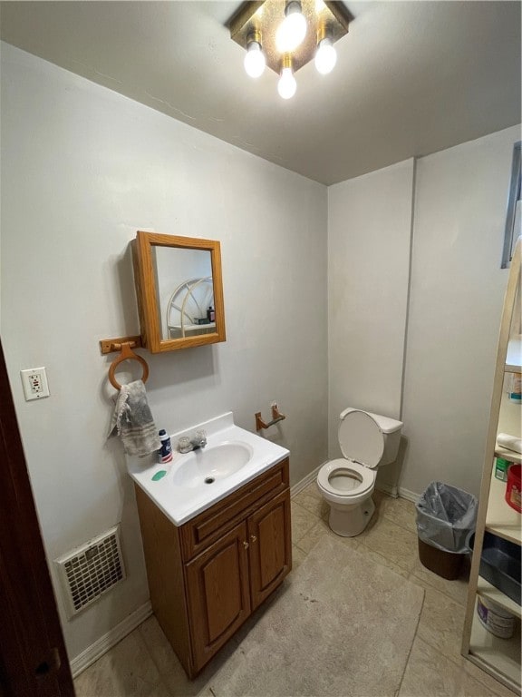 bathroom featuring vanity, toilet, and tile patterned floors