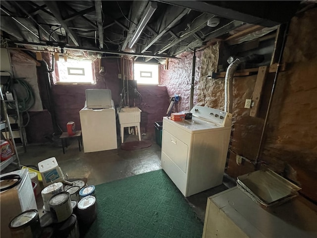 basement featuring sink and washer and dryer