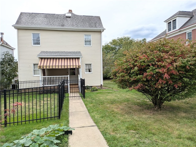 back of house with a lawn