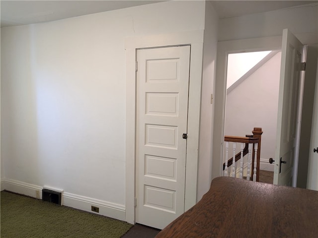 unfurnished bedroom with dark carpet