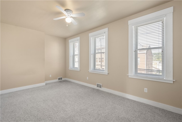 empty room featuring ceiling fan and carpet floors