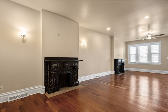 unfurnished living room featuring ceiling fan and wood-type flooring