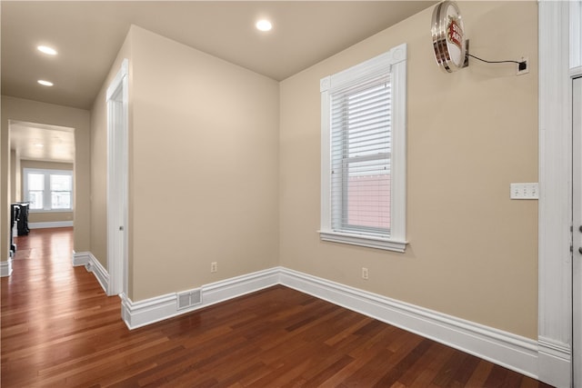 empty room with hardwood / wood-style flooring