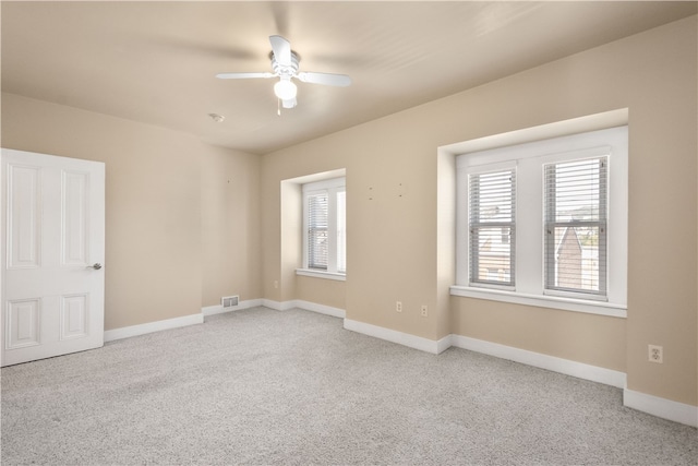 unfurnished room with light carpet, ceiling fan, and a healthy amount of sunlight