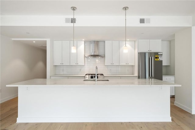 2330 Penn Ave Unit 302, Downtown Pgh, PA 15222 - kitchen featuring wall chimney range hood, freestanding refrigerator, a sink, baseboards, and a center island with sink