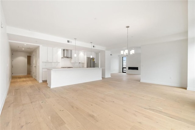 2330 Penn Ave Unit 302, Downtown Pgh, PA 15222 - unfurnished living room featuring light wood-type flooring, baseboards, and a sink