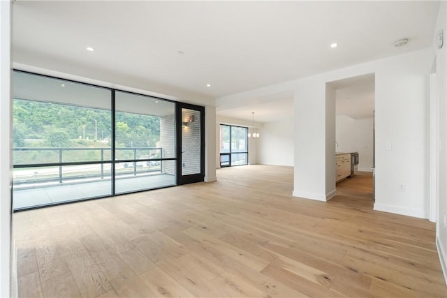 2330 Penn Ave Unit 302, Downtown Pgh, PA 15222 - spare room featuring light wood-style flooring, a chandelier, baseboards, a smoke detector, and recessed lighting