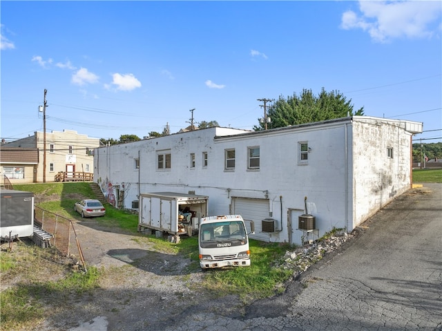 rear view of property featuring a garage