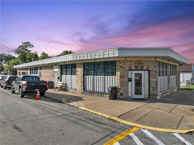 view of outdoor building at dusk