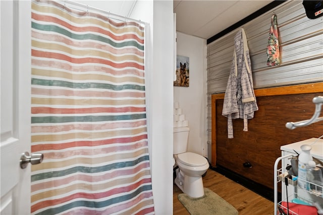 bathroom featuring hardwood / wood-style flooring and toilet