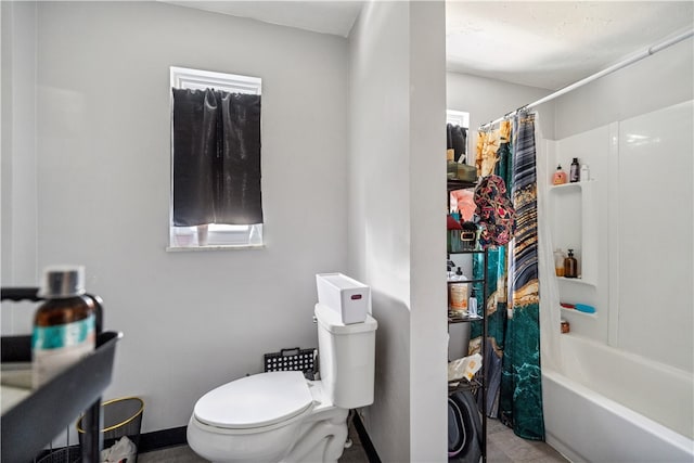 bathroom featuring shower / bath combo and toilet