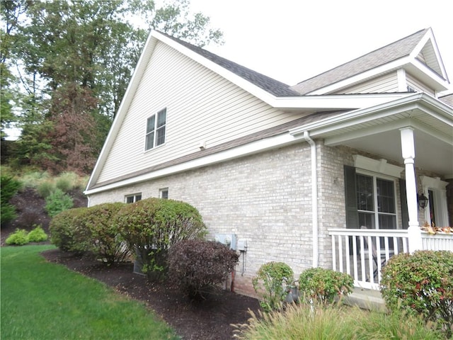 view of property exterior with covered porch