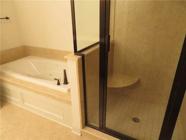 bathroom featuring tile patterned floors and separate shower and tub