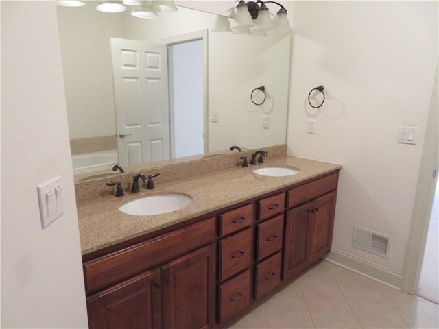 bathroom featuring a chandelier, vanity, and tile patterned floors