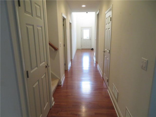 corridor featuring dark wood-type flooring