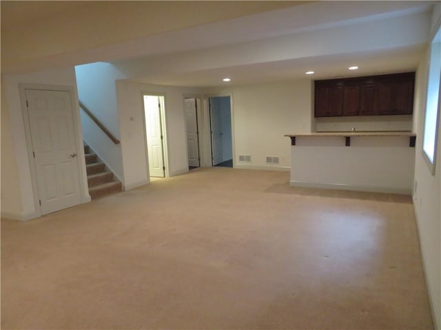 unfurnished living room with light colored carpet