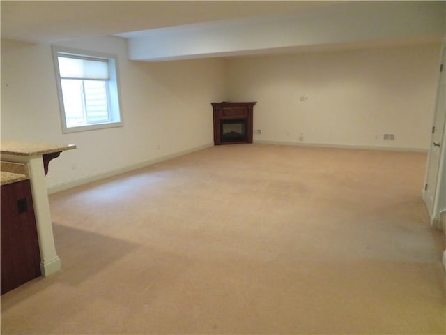 unfurnished living room with light carpet