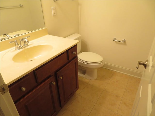 bathroom featuring tile patterned floors, vanity, and toilet