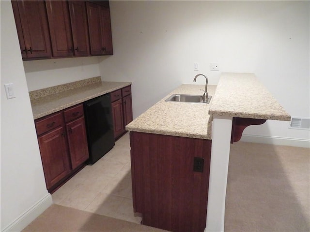 kitchen featuring a breakfast bar area, kitchen peninsula, sink, and black dishwasher