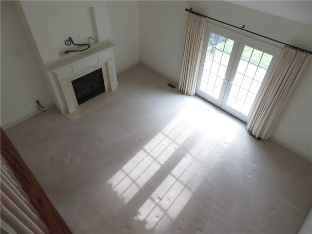 unfurnished living room featuring french doors