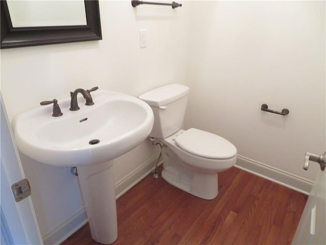 bathroom featuring sink, hardwood / wood-style floors, and toilet