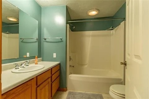 full bathroom with tile patterned floors, shower / washtub combination, vanity, and toilet