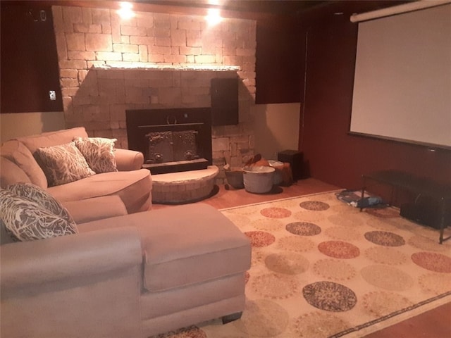 cinema room featuring wood-type flooring and a fireplace