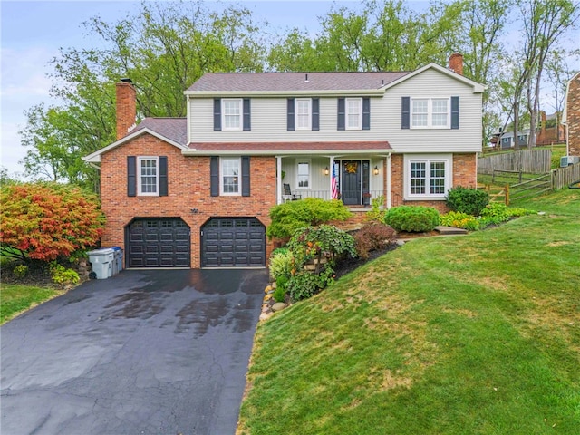 view of front facade featuring a front lawn and a garage