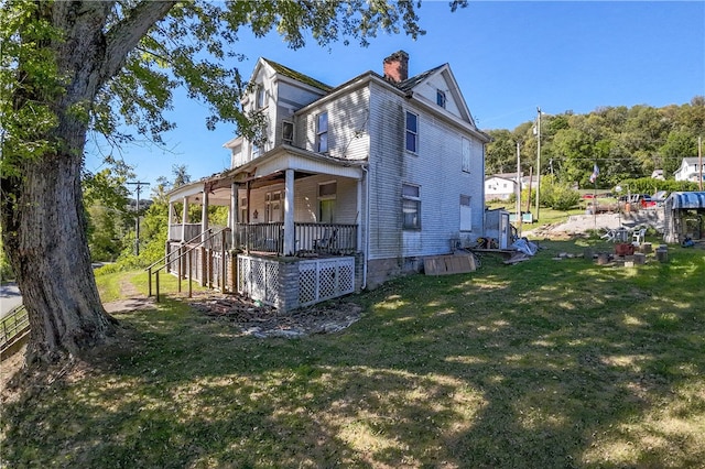 view of home's exterior featuring a yard and covered porch