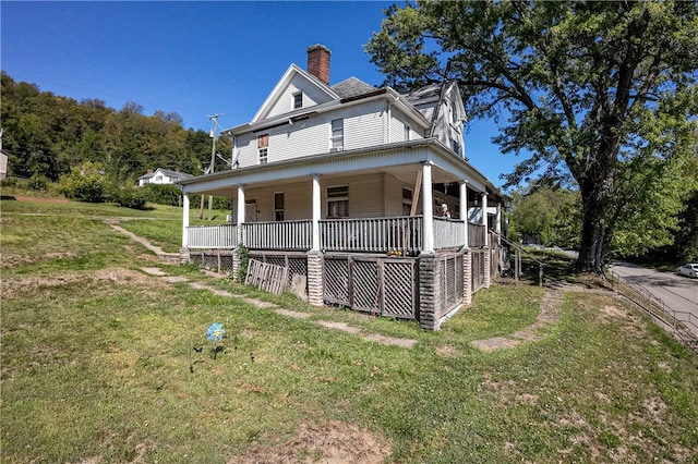 view of front facade with covered porch and a front yard