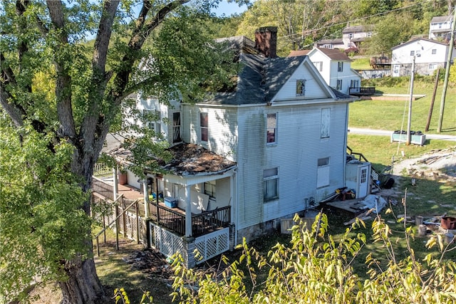 view of home's exterior featuring a wooden deck and a lawn