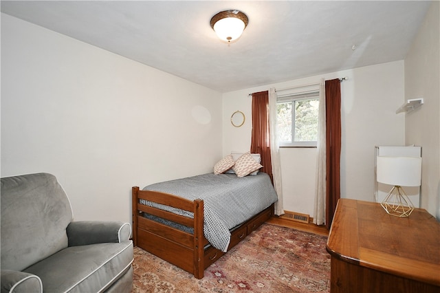 bedroom with hardwood / wood-style floors