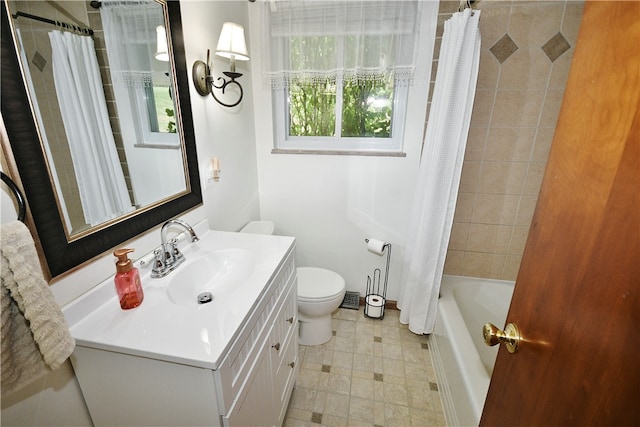 full bathroom with vanity, shower / bath combo with shower curtain, and toilet