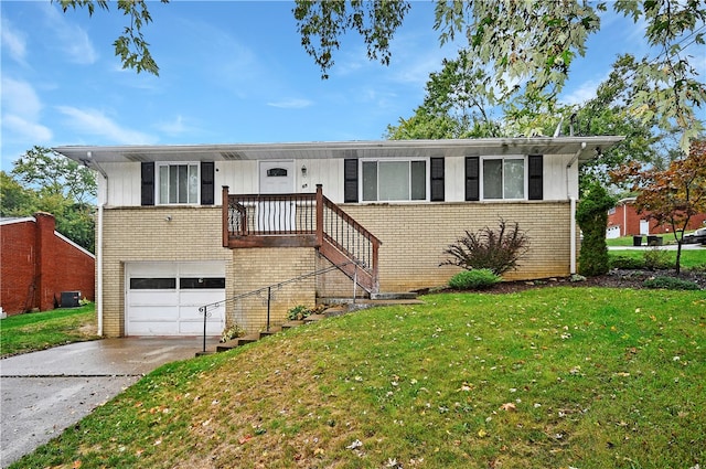 view of front of property with a front yard and a garage