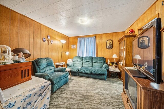 living room with wood walls and carpet flooring