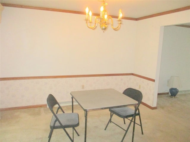 dining room with ornamental molding, an inviting chandelier, and light carpet