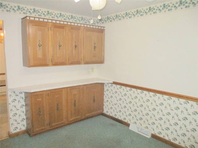 kitchen featuring light colored carpet