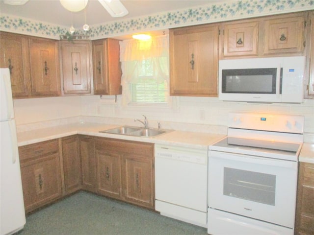 kitchen featuring white appliances, tasteful backsplash, and sink