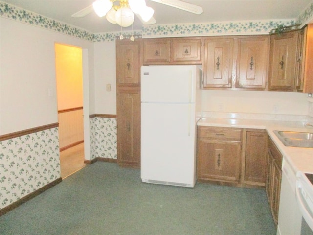 kitchen featuring light carpet, sink, ceiling fan, and white refrigerator