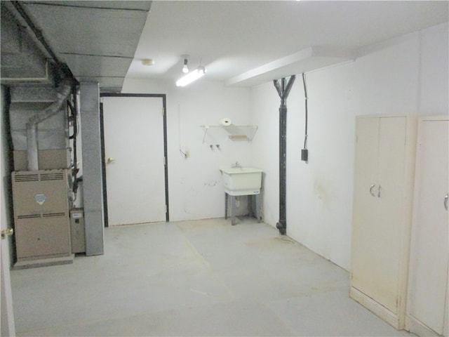 basement with heating unit and sink