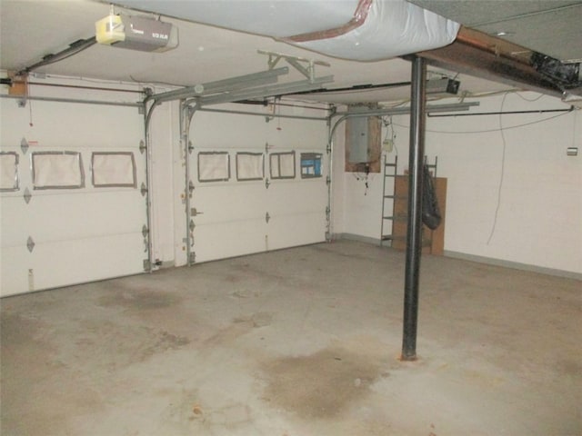 garage with a garage door opener and electric panel