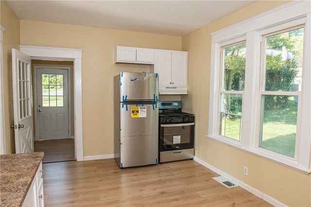 kitchen featuring appliances with stainless steel finishes, plenty of natural light, and light hardwood / wood-style floors