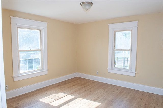 unfurnished room with a wealth of natural light and light hardwood / wood-style floors