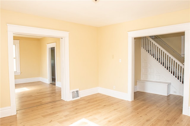 empty room with light hardwood / wood-style flooring